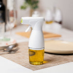White spray bottle with oil on a kitchen counter