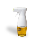 Spray bottle with white nozzle and glass container filled with oil on a white background