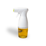 Spray bottle with white nozzle and glass container filled with oil on a white background